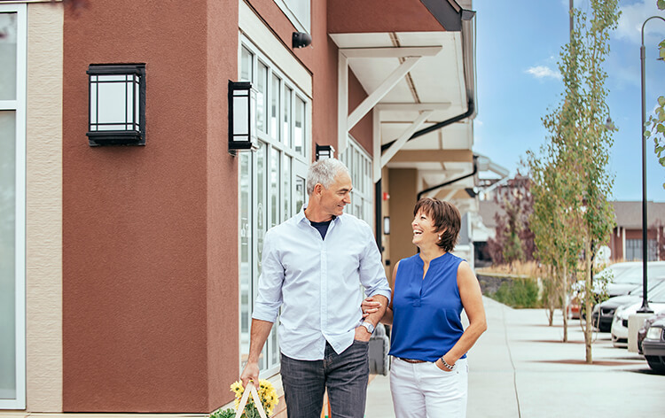 Older couple staring at each other while walking