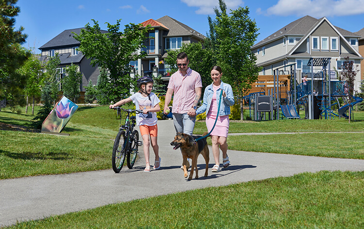 Family walking their dog on pathway