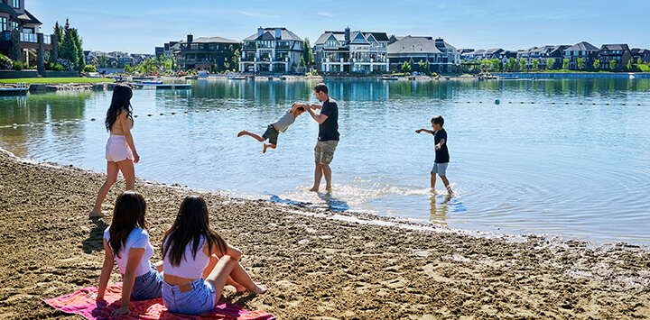 Family playing in the water along the beach