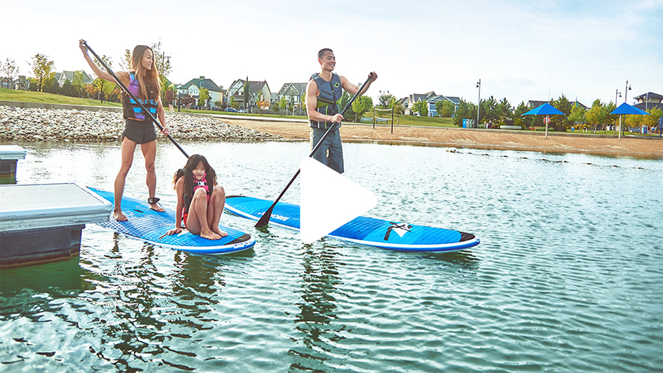 Couple paddleboarding with daughter on Mahogany Lake